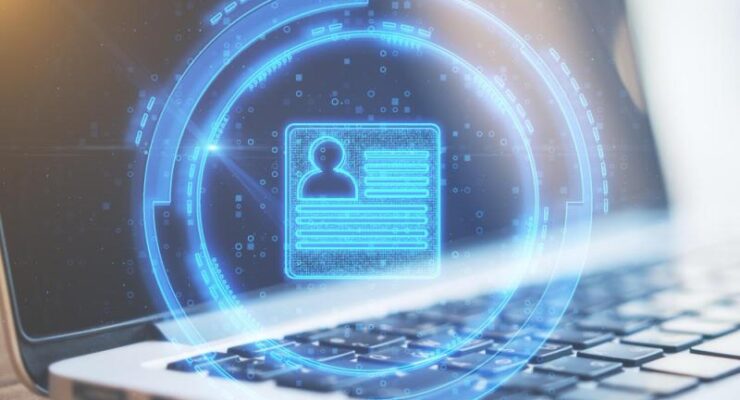 Glowing blue digital profile card floating above a laptop keyboard, symbolizing online identity verification.